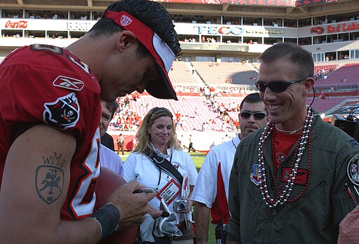 Tampa Bay Buccaneers wide receiver Joe Jurevicius autographs a game ball for Capt. Ryan Silver, a pilot from the 89th Flying Training Squadron at Sheppard Air Force Base, Texas