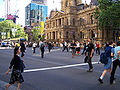 Sydney Town Hall, with pedestrians crossing George Street, Sydney