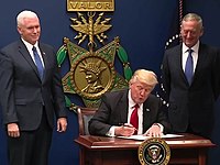 U.S. President Donald Trump signing the order at the Pentagon, with Vice President Mike Pence (left) and Secretary of Defense Jim Mattis in 2017 Trump signing order January 27.jpg