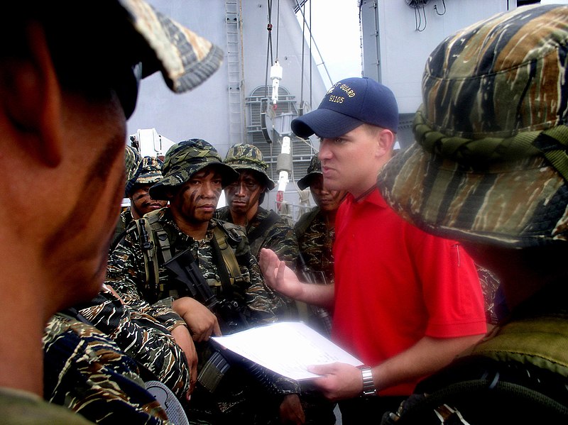 File:US Navy 050526-N-4104L-001 A U.S. Coast Guard law enforcement specialist debriefs members of a Philippine Navy SEAL team following a visit, board, search and seizure (VBSS) exercise aboard the dock landing ship USS Fort McHenry.jpg