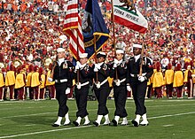 US Navy 080101-N-8607R-062 The Naval Base Ventura County Honor Guard parades the colors as the University of Southern California Marching Band performed the national anthem during the 2008 Rose Bowl game.jpg