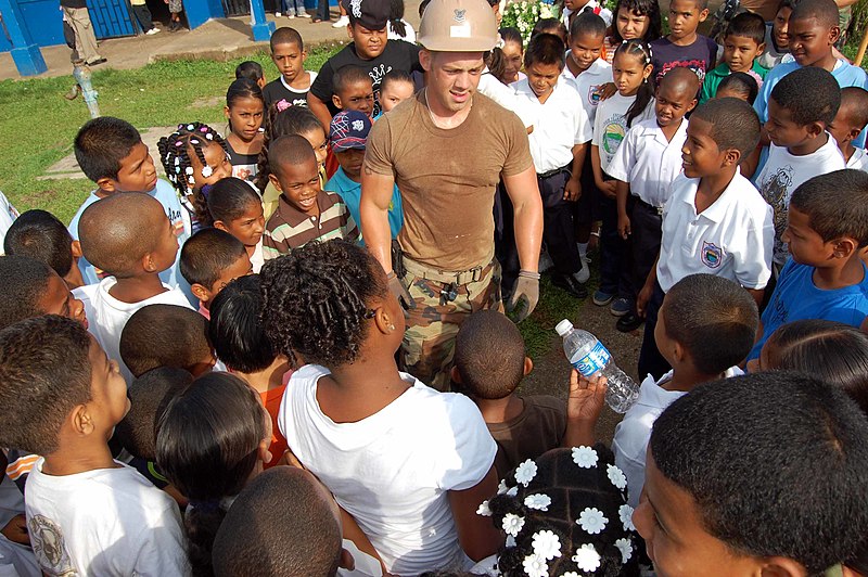 File:US Navy 090528-F-7522G-075 Steelworker 2nd Class Charles Smith, embarked aboard the Military Sealift Command hospital ship USNS Comfort (T-AH 20), jokes with a group of students at Escuela Efrain Tejada during a Continuing Pro.jpg