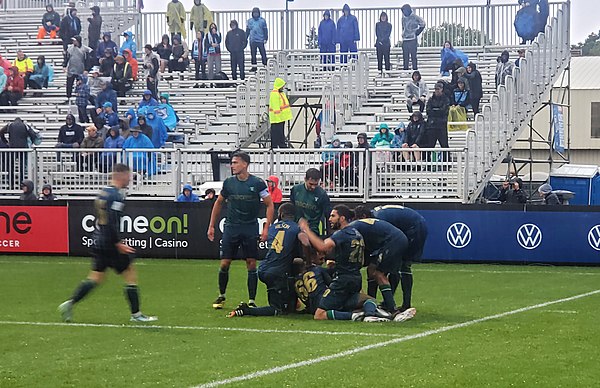 York United players celebrate a goal by Álvaro Rivero against HFX Wanderers during a game in September 2021.