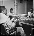 Steward's mates polishing silverware in the wardroom of the former aircraft carrier USS Ticonderoga (CV 14)