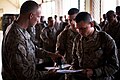 A U.S. Marine gets his orders stamped during in-processing in support of Exercise African Lion 201 (6915060850).jpg