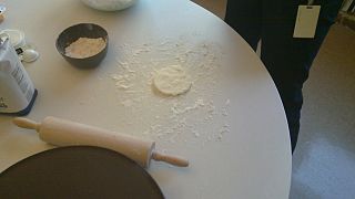 A bit of dough on a table, in preparation for rolling out.