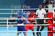 Deutsch: Boxen bei den Olympischen Jugendspielen 2018 Tag 12, 18. Oktober 2018 - Finale Fliegengewicht Mädchen – Martina La Piana (Italien, blau) schlägt Adijat Gbadamosi (Nigeria, rot) 5-0; Ringrichter ist James Beckles (Trinidad und Tobago). English: Boxing at the 2018 Summer Youth Olympics on 18 October 2018 – Girl's flyweight Gold Medal Bout - Martina La Piana (Italy, blue) beats Adijat Gbadamosi (Nigeria, red) 5-0; Referee is James Beckles (Trinidad and Tobago). Español: Boxeo en los Juegos Olímpicos Juveniles de Verano de 2018 en 18 de octubre de 2018 - Combate a medalla de oro de peso mosca para mujeres: Martina La Piana (Italia, azul) le gana a Adijat Gbadamosi (Nigeria, roja) 5-0; El árbitro es James Beckles (Trinidad y Tobago).