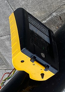 Cone on the right hand side of the underside of a pelican crossing control box Broken pelican crossing WAIT box (cropped).jpg