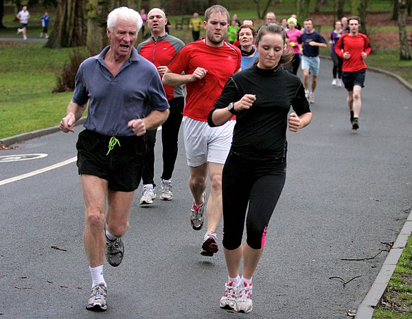 Runners during a 5k Parkrun in Cannon Hill Park, United Kingdom