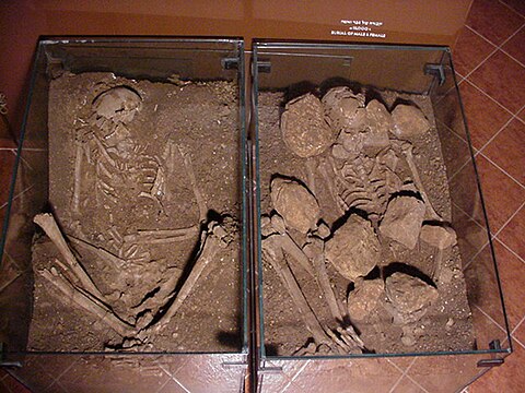 Fotografia de duas sepulturas com esqueletos.