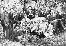 Members of The 13 Generation. From left to right, standing: Exequiel Plaza, Claudio de Alas, Tony Rogers (theatre operator), Alberto Lobos, Alberto Romero, Pedro Luna, Jose Backhaus, Lautaro Garcia, Julio Ortiz de Zarate, Camilo Mori and Alfredo Lobos. Sitting in the middle: Julio Vasquez Cortes, Carmen Tortola Valencia, Carlos Predes Saldias and Luis Johnson. Sitting on the floor: Enrique Lobos, Manuel Gallinato, Fernando Meza and Julio Walton. Generacion del trece retrato.jpg