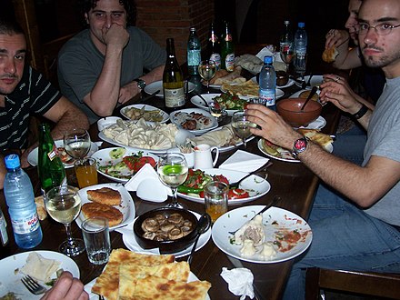 Guests partaking in a supra, a Georgian banquet