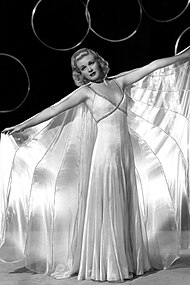 Ginger Rogers in the 1936 film Swing Time, wearing a silk nightgown and matching cape designed by Bernard Newman.