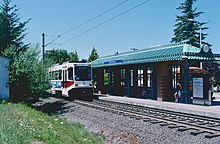 Photograph of Greshan Central Station showing a train with the station platform in the background