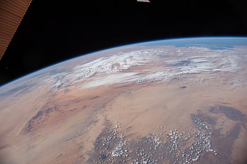 Dry Sahara Desert, volcano Tousside and clouds, a view to Mediterranean Sea, volcano Waw an-Namus in North