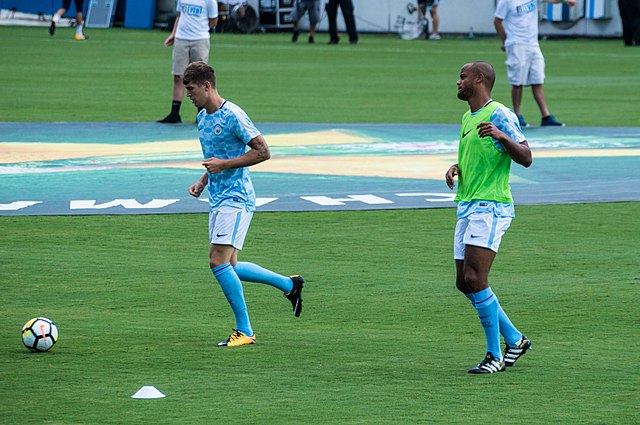 Stones (left) warming up for Manchester City in 2017