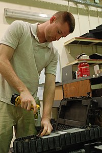 A US armed forces robot technician repairing the tread of a mine disposal robot Joint Robotics Repair Detachment keeps robots mission ready DVIDS269095.jpg