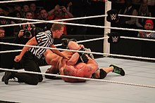 Lesnar performing the Kimura lock on John Cena