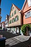 The photo shows a medieval house on a medieval street.