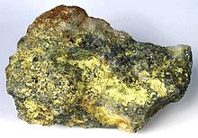 Molybdite on molybdenite, Questa molybdenum mine, New Mexico (size: 11.0x6.7x4.1 cm). Molybdite-Molybdenite-233200.jpg