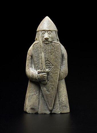 A rook piece from the Lewis chessmen, depicted as a warrior biting his shield