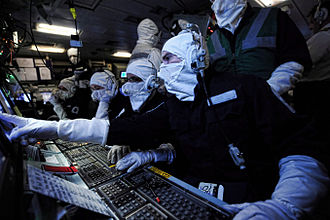 Operations room staff on board HMS Illustrious during a Thursday War. The operations room on board the ship is the hub of the vessel's sensors, and it is from here that her weapons systems are directed. Operations Room Staff Onboard HMS Illustrious During an Exercise MOD 45153376.jpg
