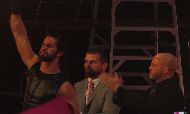 Noble (center) with J&J Security partner Joey Mercury (right) and Seth Rollins (left) in December 2014