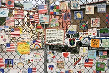 Series of hand-painted tiles, dedicated to the victims of the September 11 attacks, on the fence of a car-lot in New York City Sept 11 monument in NYC - August 2004.jpg