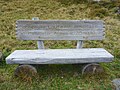 Wooden bench in memory of composer Hans Roelli in skiing area of Arosa, Switzerland