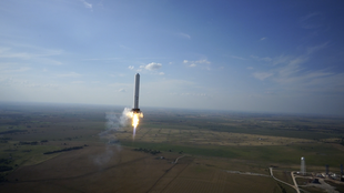 Grasshopper rocket, in 2013, performing a 325 meter flight followed by a soft propulsive landing in an attempt to develop technologies for a reusable launch vehicle SpaceX Grasshopper rocket midflight.png