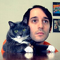 a photograph of the musician Shai Halperin and his cat Yuri