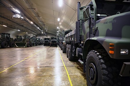 United States Marine Corps front loaders and 7-ton trucks in the Frigard supply cave during 2012 USMC trucks stored inside a cave in Norway.jpg