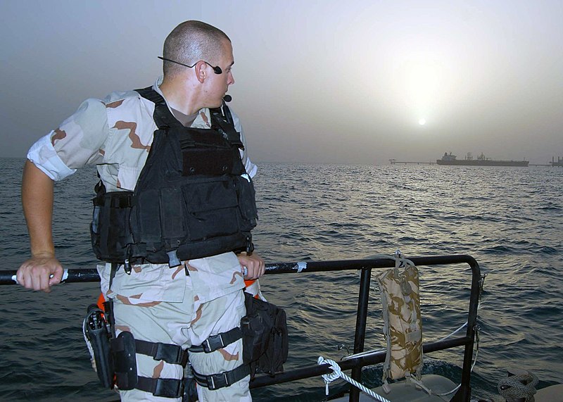 File:US Navy 070720-N-0515W-098 Ensign Scott Jennings, a member of dock landing ship USS Rushmore (LSD 47), watches the sun rise over one of Iraq's oil platforms.jpg