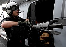 An AW performs maintenance on a .50-caliber crew-served weapon aboard the aircraft carrier USS Dwight D. Eisenhower US Navy 090124-N-4750W-025 Aviation Warfare Systems Operator 3rd Class David Bellows, assigned to the.jpg