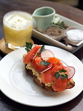 Egg salad and smoked salmon on a slice of toasted baguette