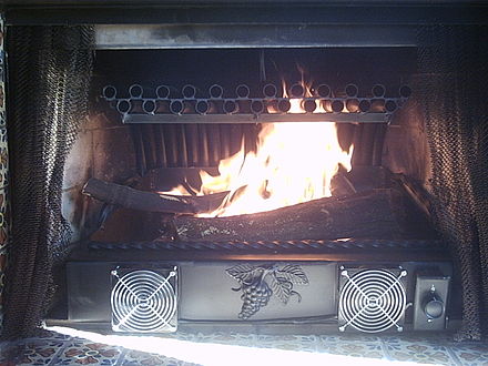 Fireplace with tubular grate heater, with a high surface area in its heat exchanger and a lift out ash tray to simplify cleanup
