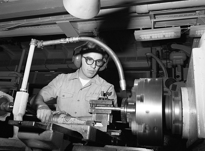 File:A crewman operates a lathe aboard the repair ship USS AJAX (AR 6) - DPLA - 729d32fce613949e9507b707656df253.jpeg