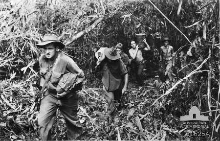 Australian troops from the 2/24th Infantry Battalion carry supplies up from Sattelberg towards the 2/23rd Infantry Battalion as they advanced towards 