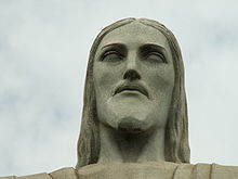 Close-up of the face of Christ the Redeemer in Rio de Janeiro, Brazil. It is made of reinforced concrete clad in a mosaic of thousands of triangular soapstone tiles. Cristo Redentor head.jpg