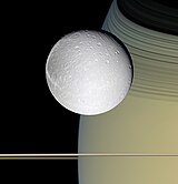 The moon Dione orbiting Saturn