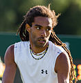 Dustin Brown competing in the first round of the 2015 Wimbledon Qualifying Tournament at the Bank of England Sports Grounds in Roehampton, England. The winners of three rounds of competition qualify for the main draw of Wimbledon the following week.