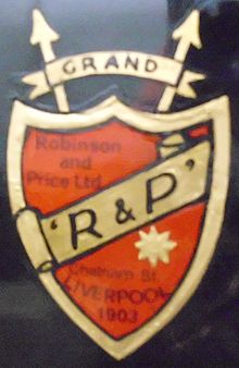 Robinson & Price logo, a red sheild with a gold stripe across it containing the writing "R & P"