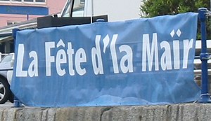 A sea festival advertised using Dgernesiais Fete d'la Mair Guernesy.jpg