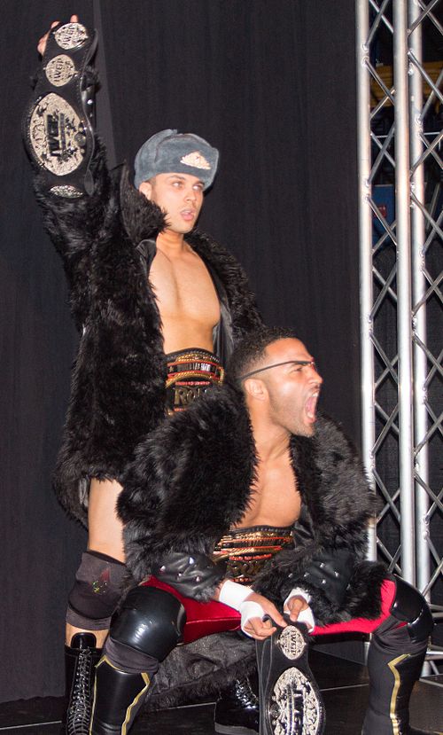 Koslov (left) and Romero with both the IWGP Junior Heavyweight Tag Team Championship and ROH World Tag Team Championship belts