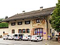 Ehemaliges Postamt in Gmund am Tegernsee, Landkreis Miesbach, Regierungsbezirk Oberbayern, Bayern. Nach Ankauf durch die Gemeinde im Jahr 2007 jetzt Stützpunkt der Diakonie. Wandmalereien bezeichnet mit dem Jahr 1938.