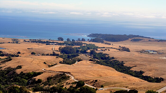 Hearst Ranch,  looking down the access road from Hearst Castle to Highway 1 and  San Simeon.  Wooded peninsula is San Simeon Point.