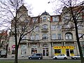 Apartment house in a corner and open development