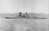 A port-side view of HIJMS Kirishima, a Japanese WWII-era battleship with a tall pagoda superstructure, off the coast of Japan in 1937