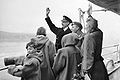 Kongefamilien vinker fra HMS Norfolk til de jublende folkemassene i Oslo 7. juni 1945. Sammen med dem er kronprins Olav (i midten iført beret) som ankom landet allerede 13. mai. Kongefamilien flyktet fra Norge etter tyskernes okkupasjon i 1940.