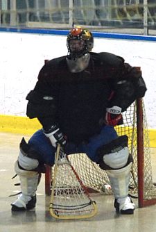 Box goalie challenging shooter on angle in basic stance. Gear typical of the early 2000s. Lacrosse goalie in stance.jpg